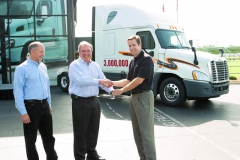 Roger Nielsen, výkonný šéf DTNA a Richard Shearing, viceprezident národních obchodních operací DTNA při předání tří miliontého vozidla Freightliner Stevovi Duleyemu, viceprezidentu odpovědnému za nákupy v dopravní společnosti „Schneider“.